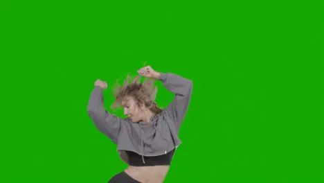 Studio Shot Of Young Woman Having Fun Dancing Against Green Screen 10