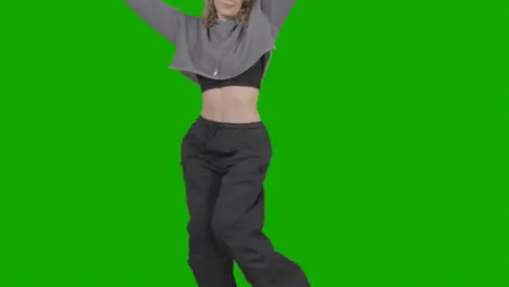 Close Up Studio Shot Of Young Woman Having Fun Dancing Against Green Screen 2