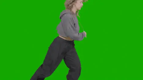 Close Up Studio Shot Of Young Woman Having Fun Dancing Against Green Screen 3