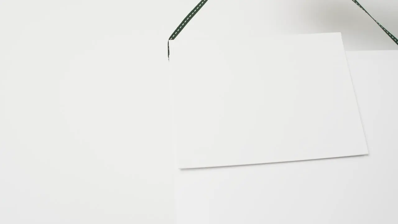 Video of books on hanger with white blank pages and copy space on white background