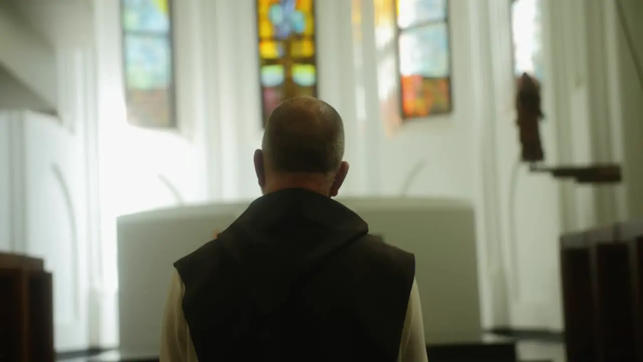 Beautiful scene of a monk praying in a church