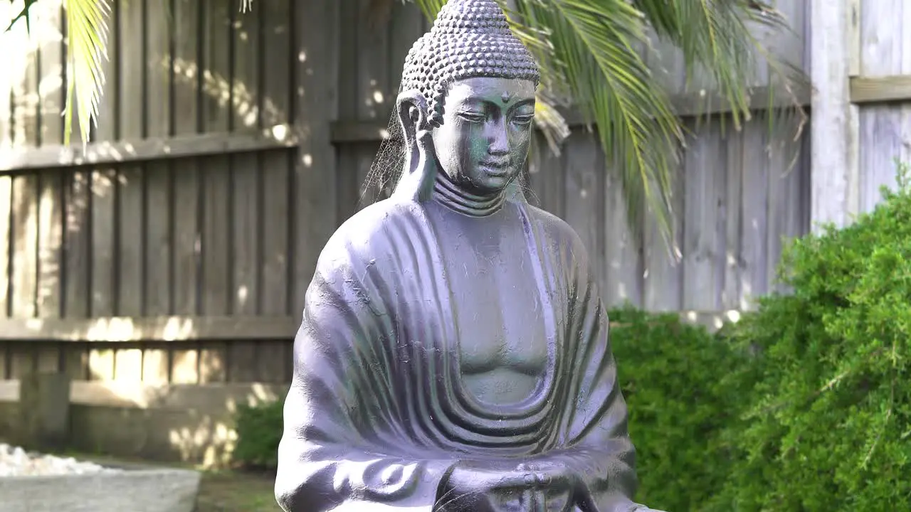 Close-up of a neglected Buddha statue covered in spiderweb