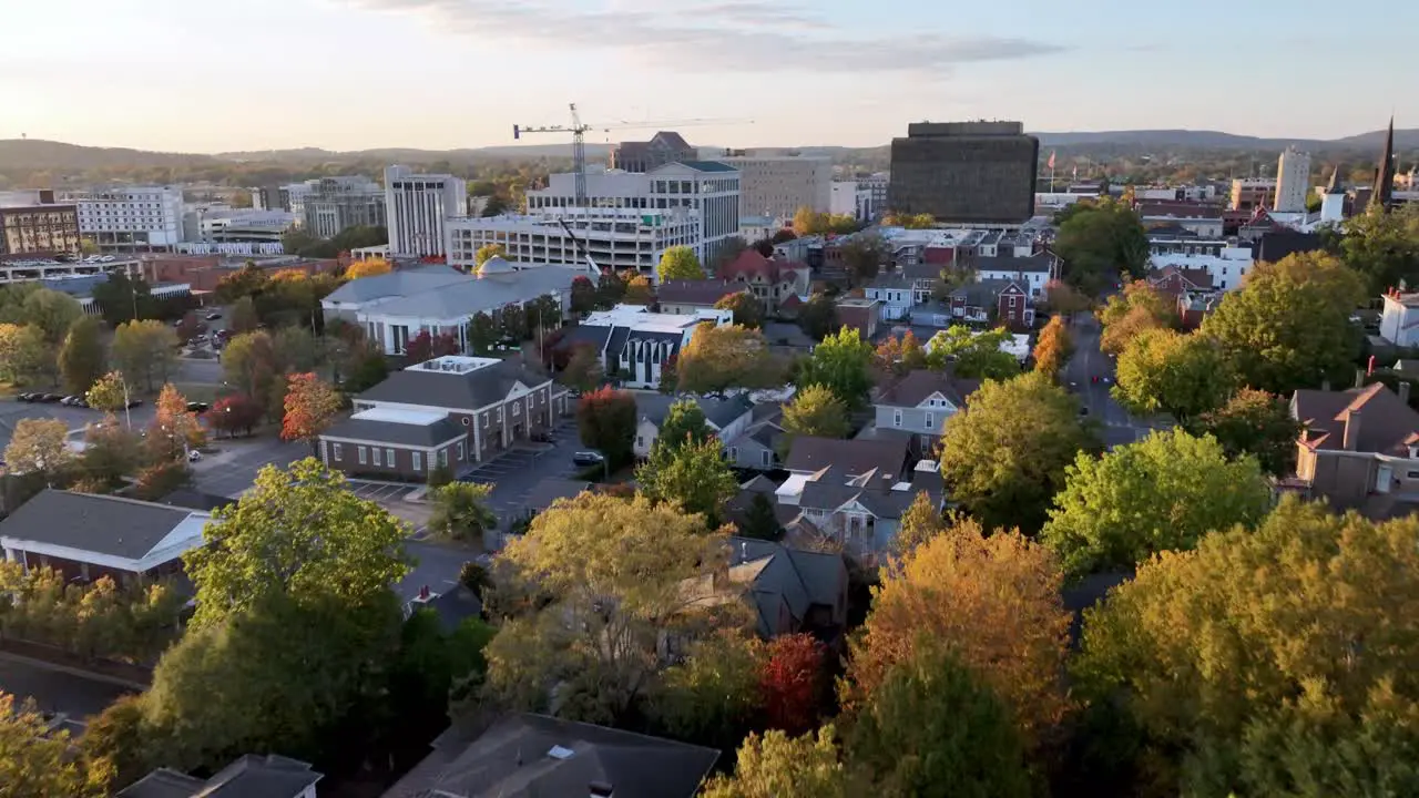 aerial fast push into huntsville alabama skyline with autumn and fall leaf color