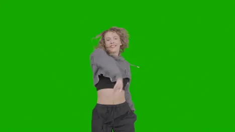 Studio Shot Of Young Woman Having Fun Dancing Against Green Screen 15