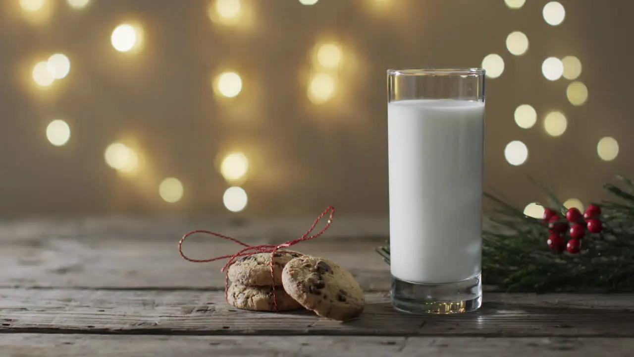 Video of christma cookies glass of milk and copy space on woodenbackground