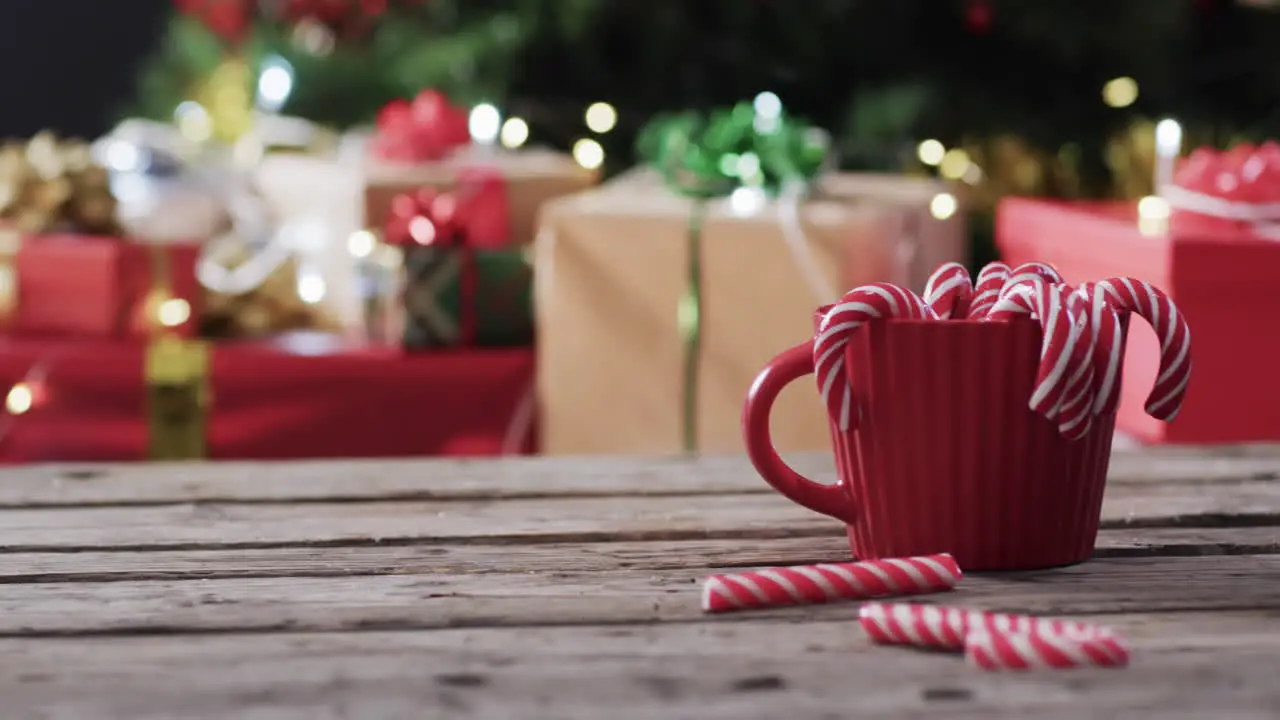 Video of red mug with christmas cnady canes and christmas presents with copy space