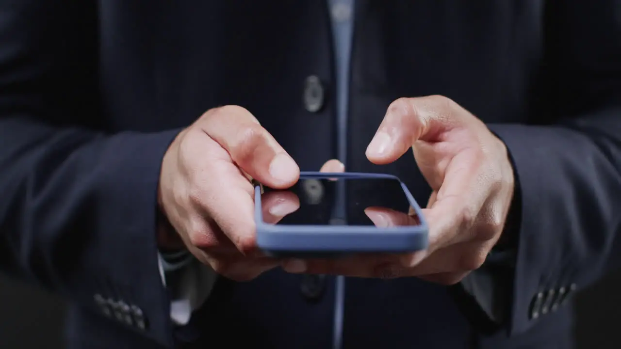 Video of midsection of biracial businessman using smartphone with holographic display copy space