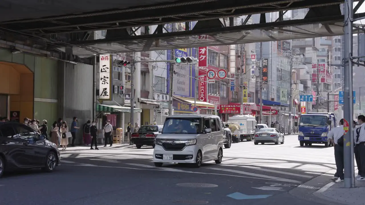 Traffic on Japanese Road at Tsuruhashi street Pan to the right shot during day