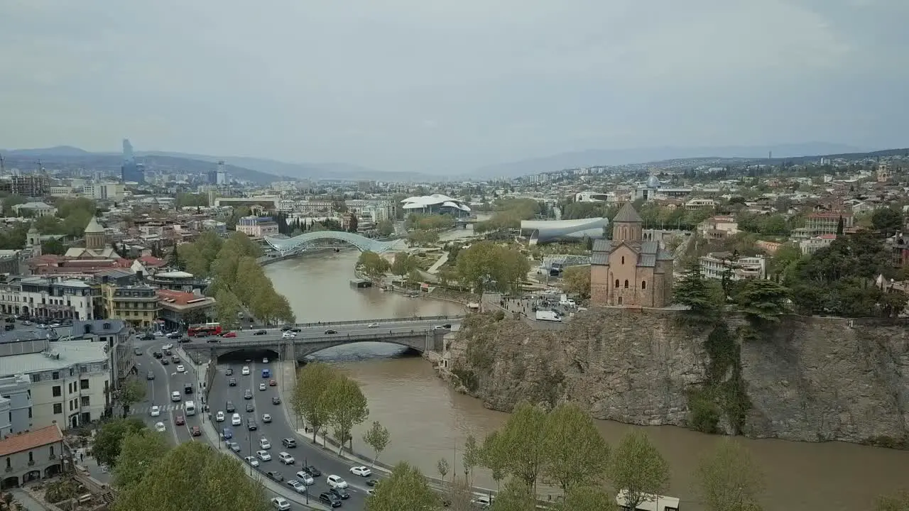 Tbilisi aerial view autumn view no sun cars passing by old town glass bridge