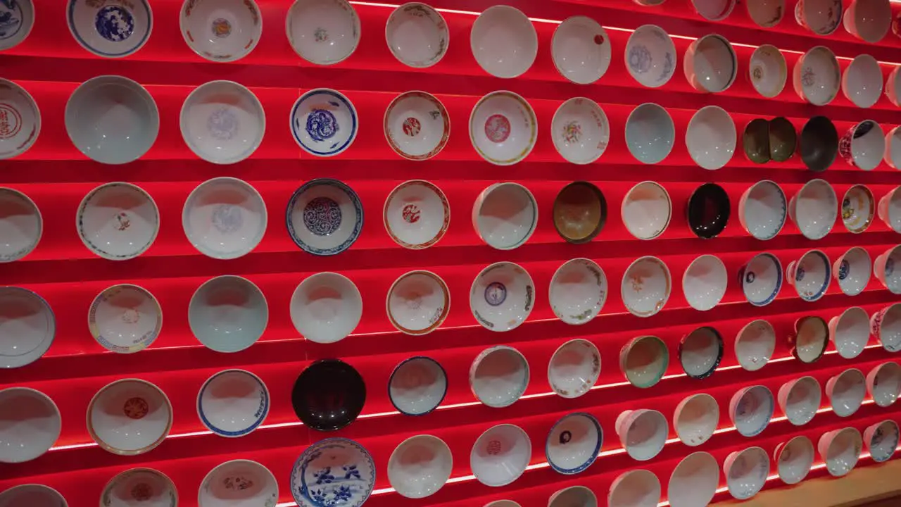 Wall of Ramen Bowls on Display Pan Shot at Yokohama Ramen Museum