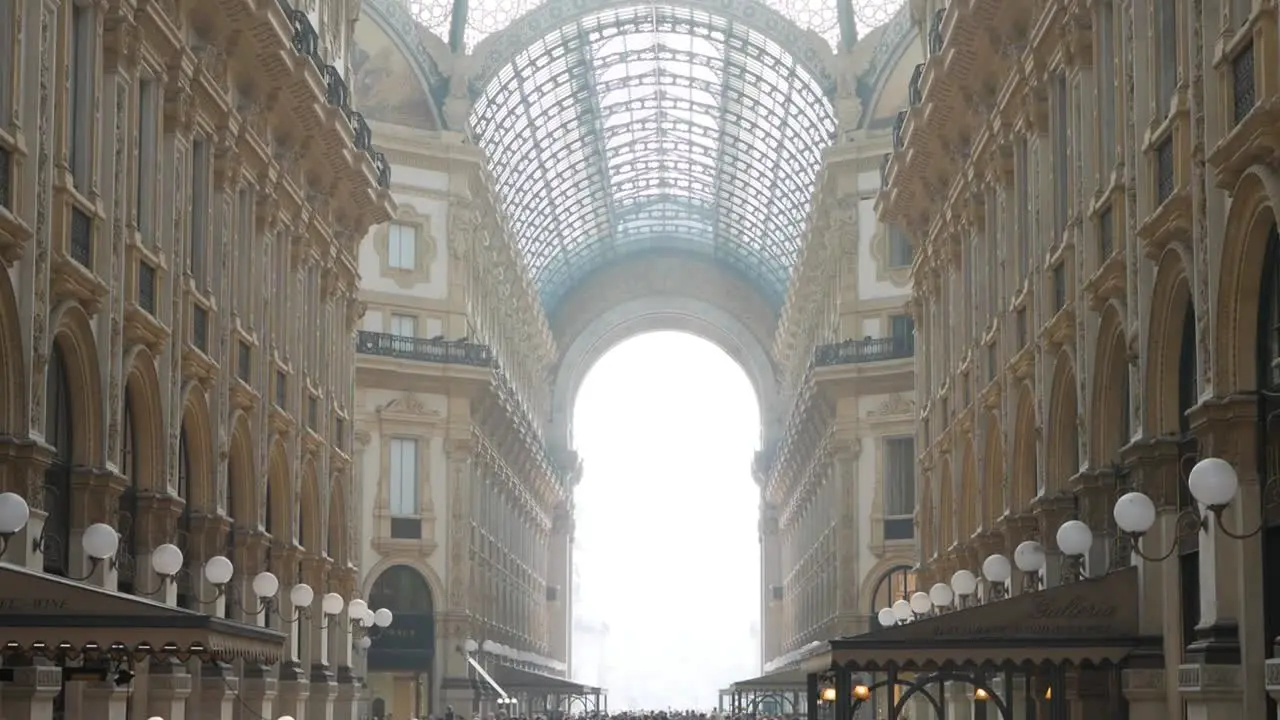 Galleria Vittorio Emanuele II in Milan city with crowds of people handheld view