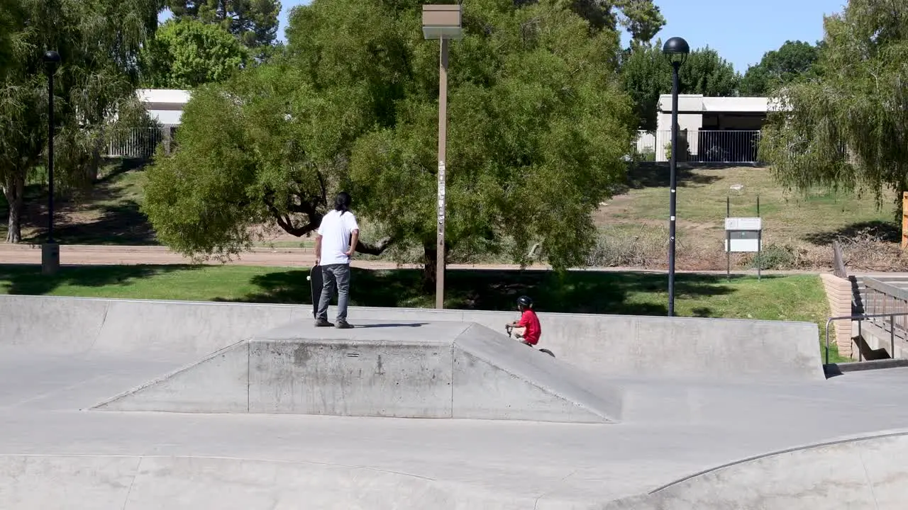 Man watch boy right his bike at the Wedge Skate Park Scottsdale Arizona