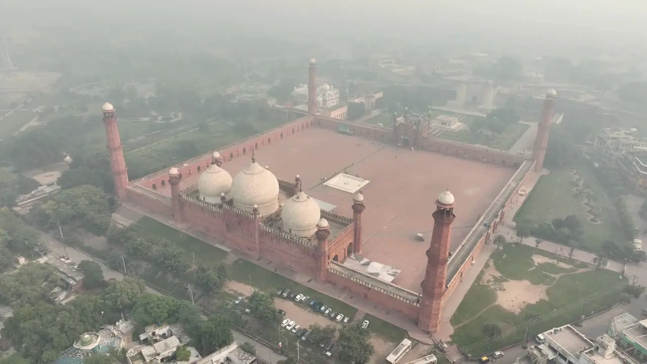 Aerial Overview Shot Of Badshahi Mosque In Lahore Pakistan Through Hazy Air