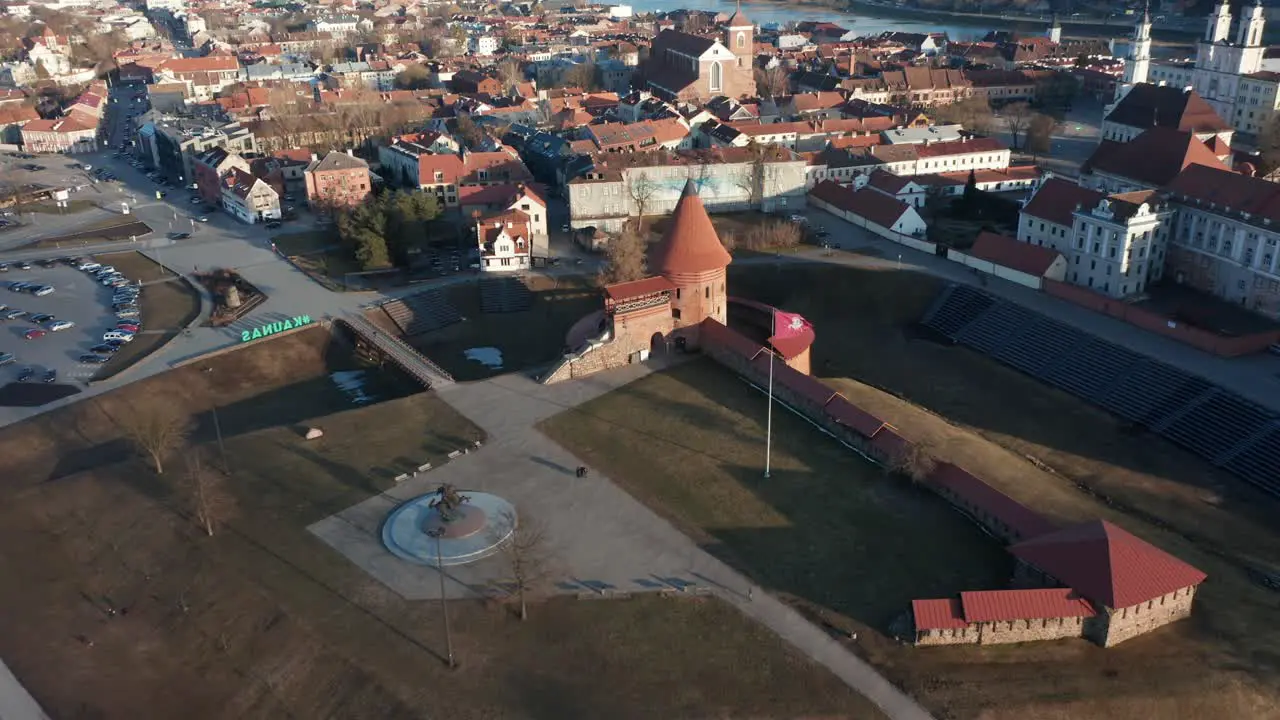 AERIAL Reveal Shot of Kaunas Castle and Oldtown in Golden Hour Evening Light