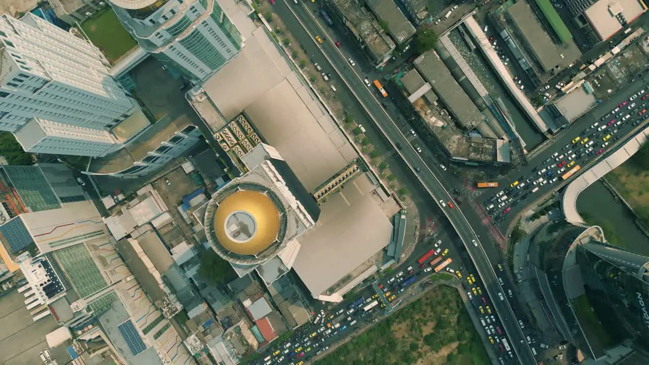 Cinematic urban drone footage of an aerial smoky view flying over skyscrapers and boulevards in the middle of downtown Bangkok Thailand during burning season looking down from a bird's point of view