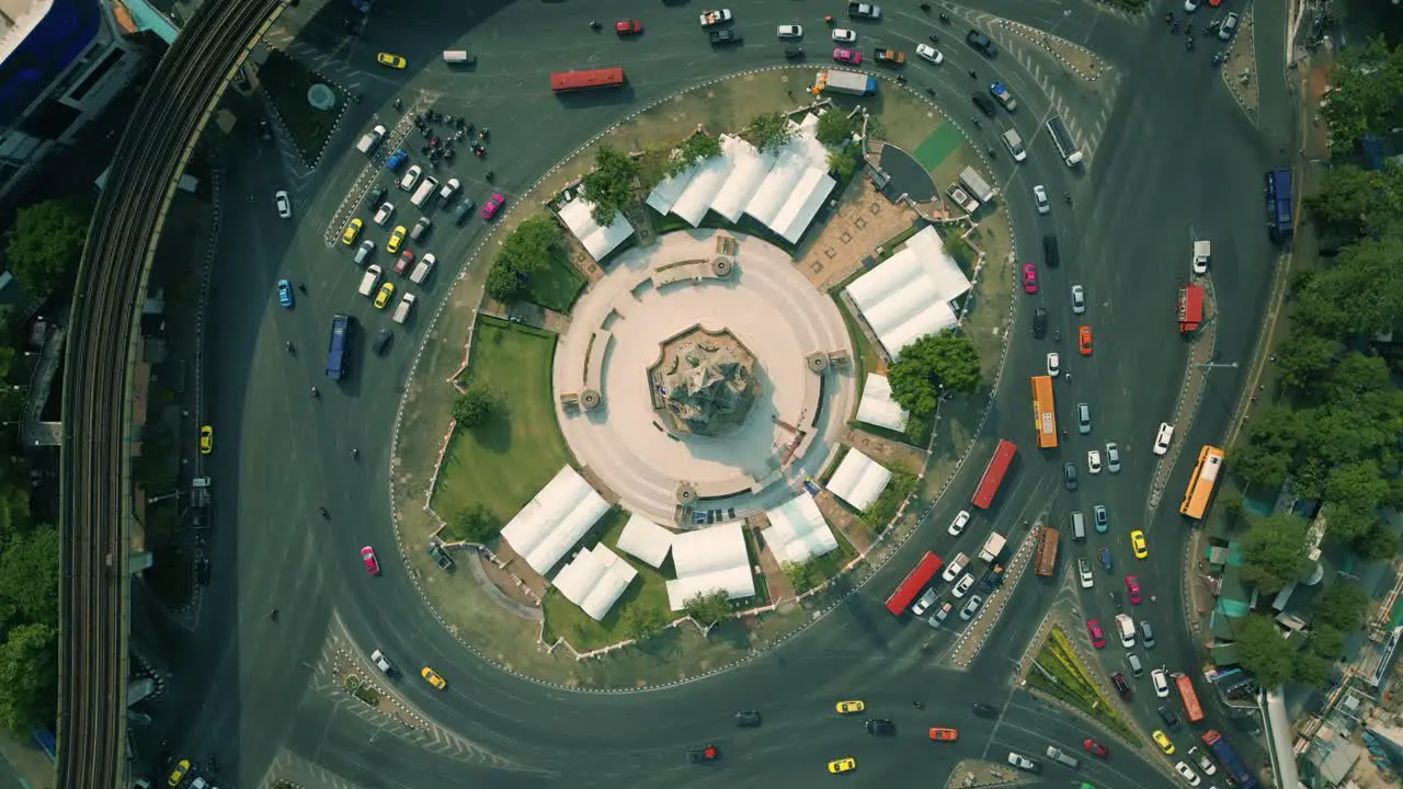 4K Cinematic urban drone footage of an aerial panoramic smoky view of the Victory Monument roundabout in the middle of downtown Bangkok Thailand during burning season