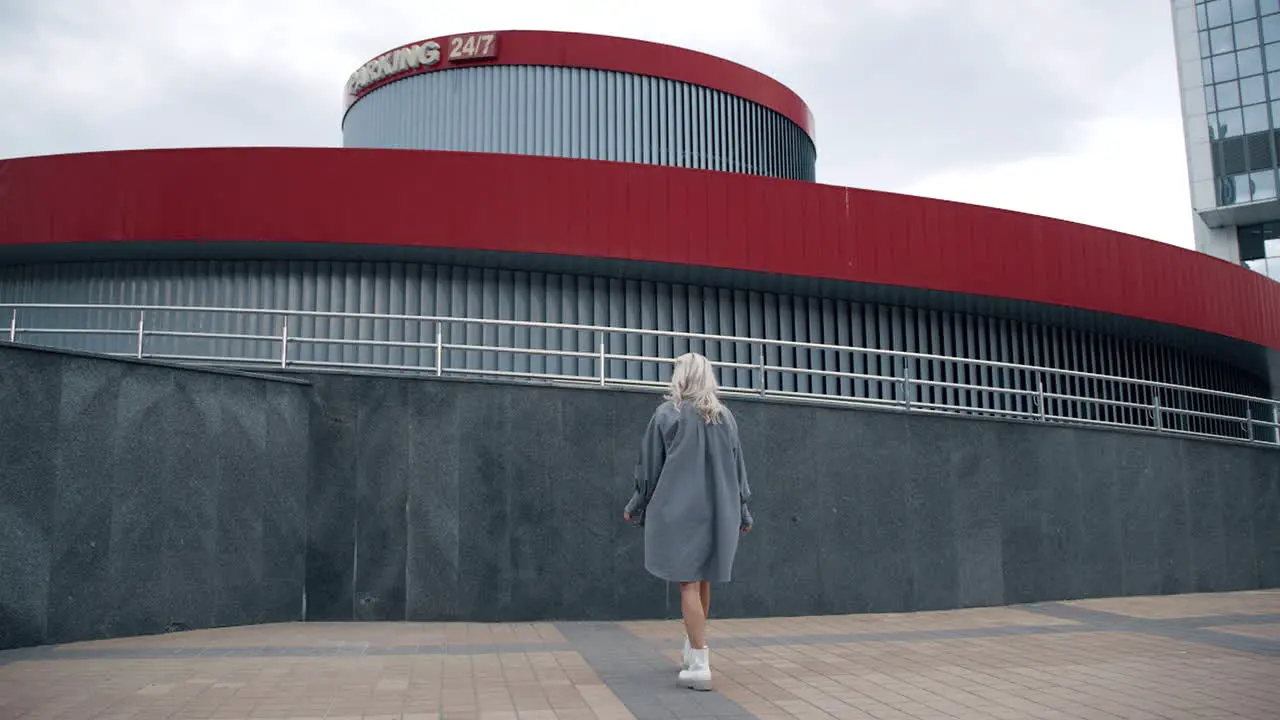 Girl walking around city in urban wear at modern buildings or street