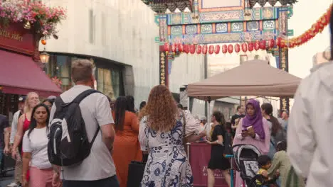 Crowd Of Summer Tourists Walking Along Wardour Street In Chinatown In London England UK