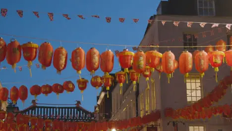 Close Up Of Paper Lanterns Across Gerrard Street In Chinatown At Dusk In London England UK