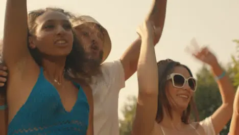 Low Angle Shot of Group of Festival Goers at Stage Barrier Enjoying Music