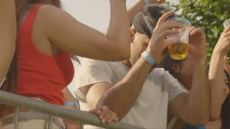 Low Angle Shot of Young Festival Goers Enjoying Music at Stage Barrier