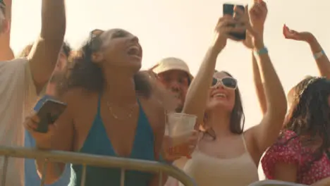 Low Angle Shot of Festival Goers at the Stage Barrier the Enjoying Music