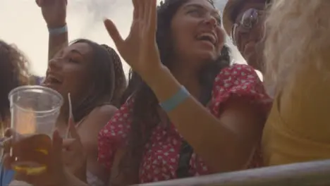 Low Angle Shot Looking Up at Festival Goers at Stage Barrier Enjoying Music