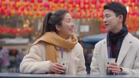 Young Asian Couple On Holiday Drinking Bubble Tea In Chinatown London UK 1