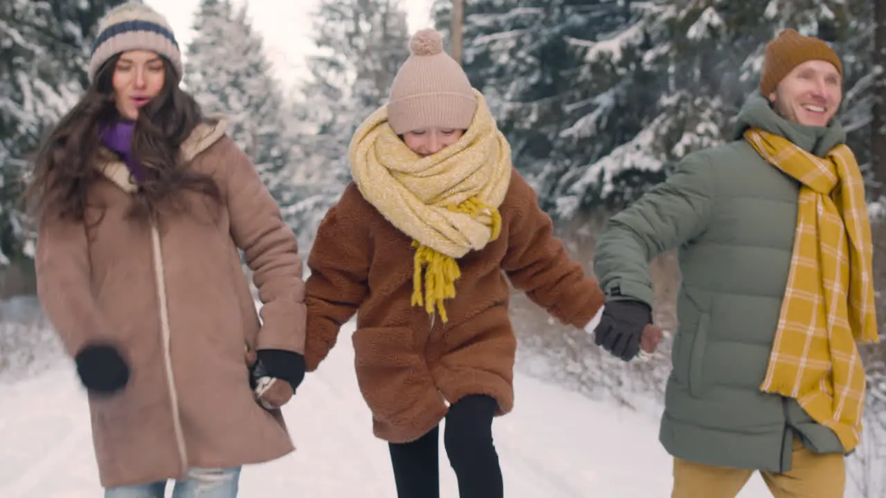 Vista De Cerca De Padres E Hija Vestidos Con Ropa De Invierno Caminando En Un Bosque Nevado