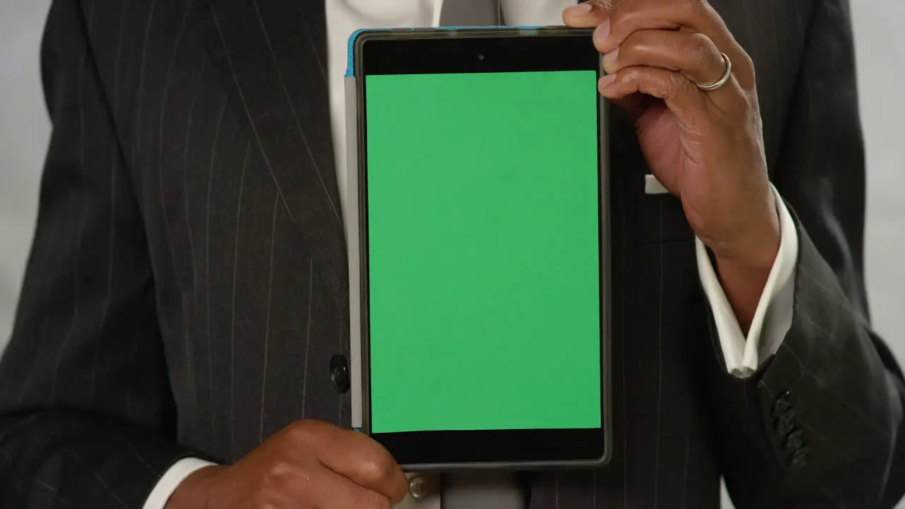 CU Man Holding Tablet at Camera with Green Screen