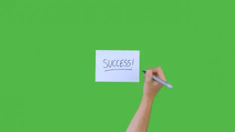 Woman Writing Success! on Paper with Green Screen