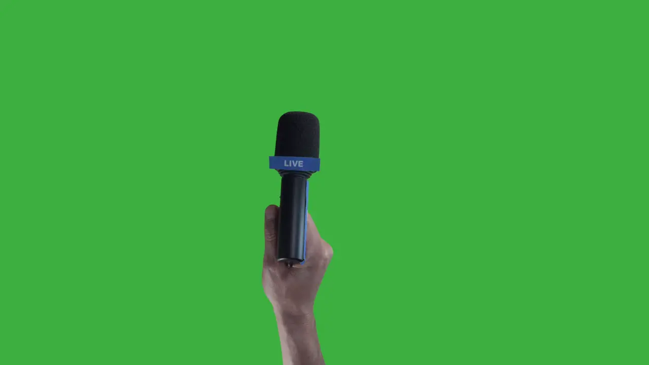 Hand holding Microphone For Live Press Conference interview with green screen