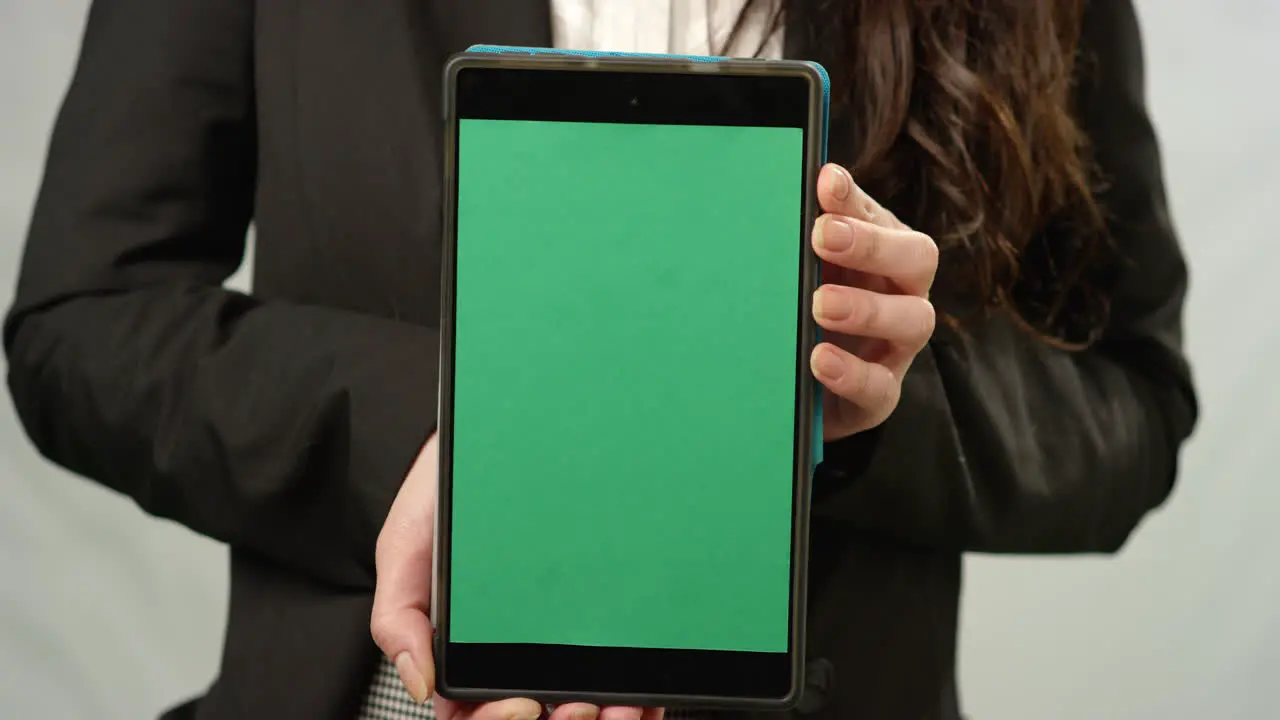 CU Woman Holding Tablet at Camera with Green Screen