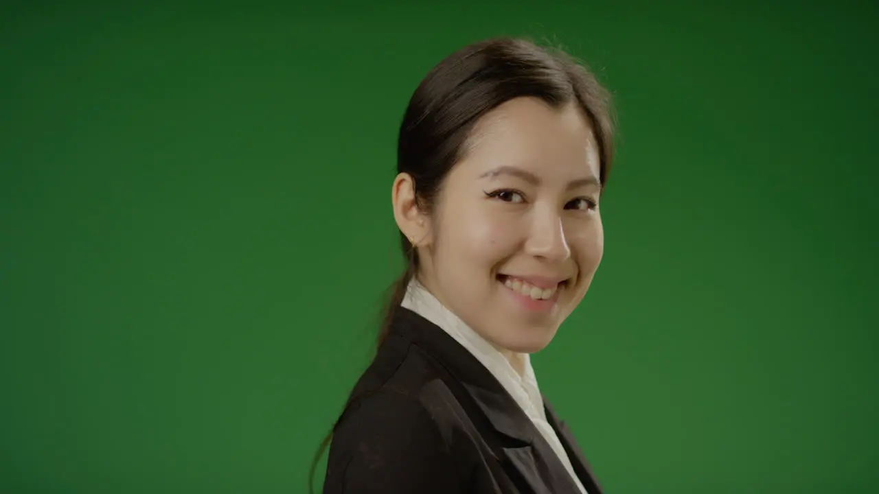 Businesswoman Smiles at Camera on Green Screen