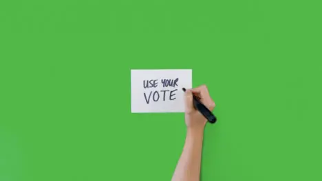 Woman Writing Use Your Vote on Paper with Green Screen