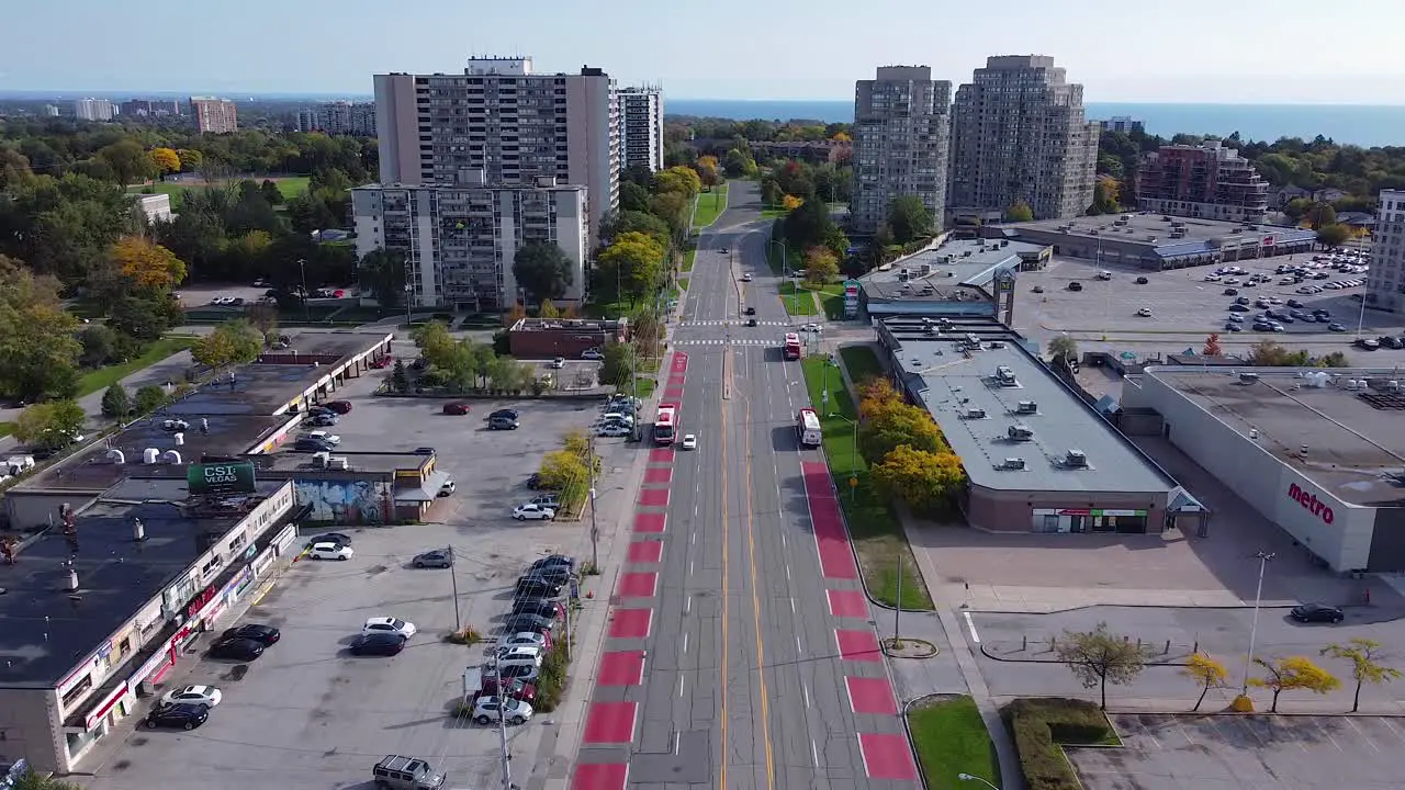 Toronto Transit Commission buses picking up passengers along bus lanes in Scarborough Village