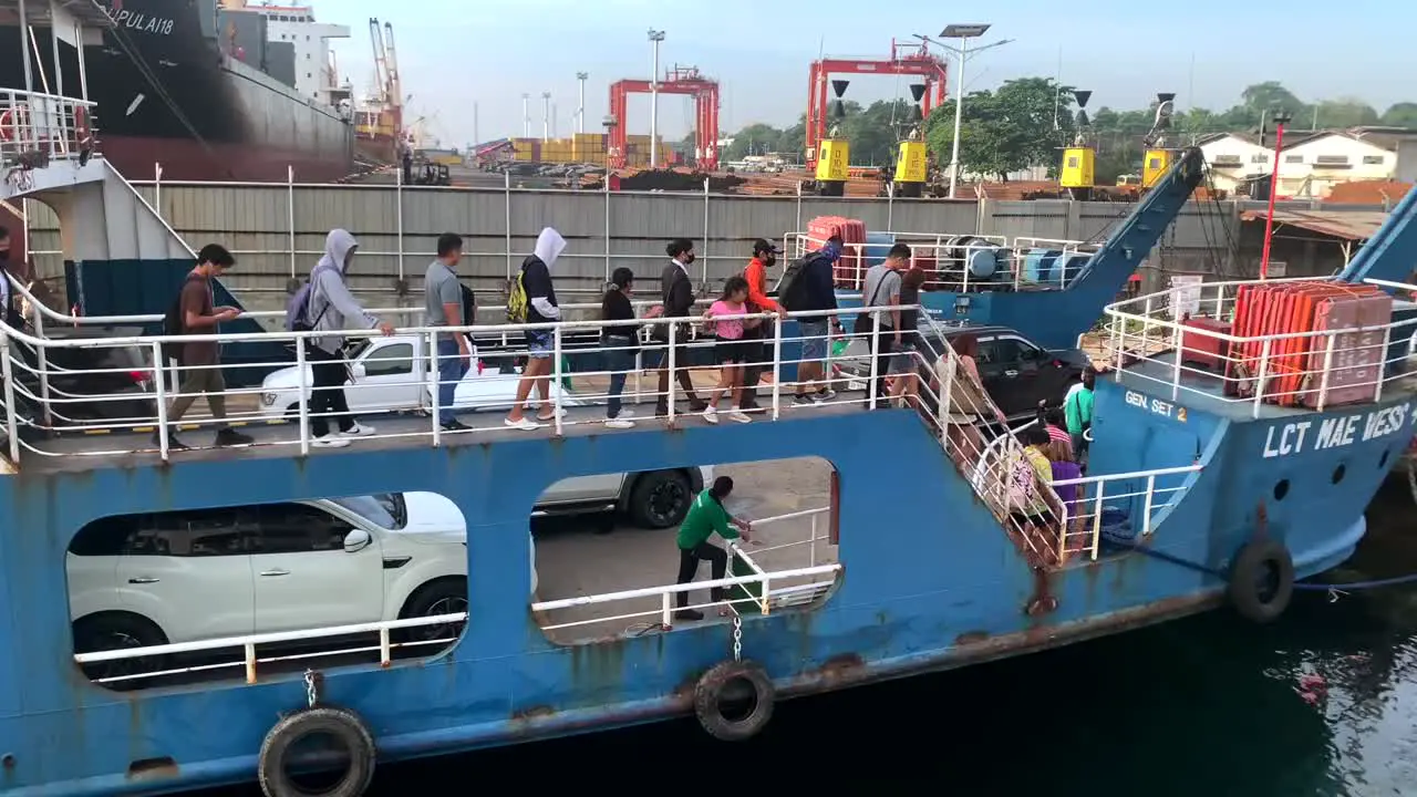 People are embarking down from a cargo ship