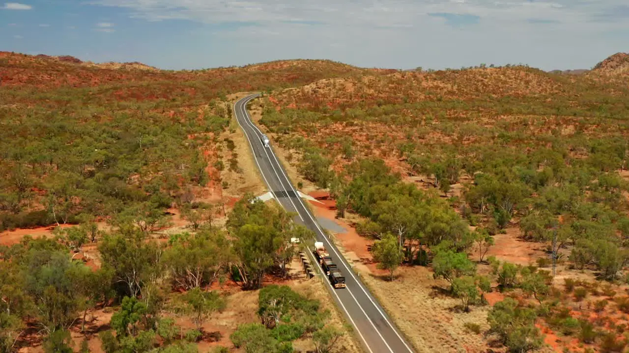 Aerial View Of Three-trailer Road Train Travelling In Outback Asphalt Road In QLD Australia