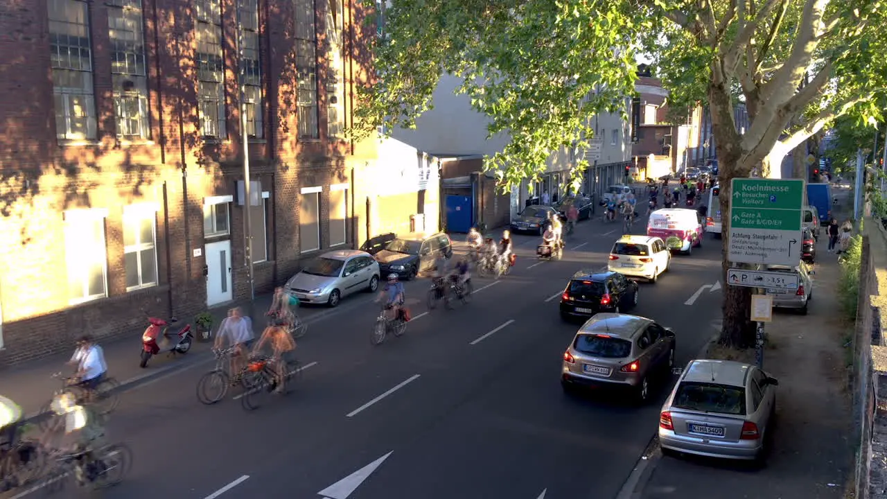 Large group of cyclists protesters come round a bend followed by police cars in the back