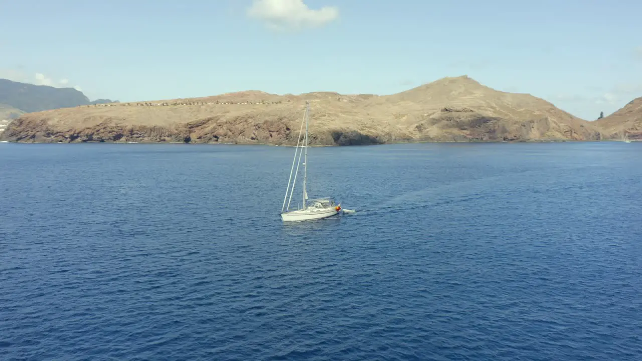 Luxury Boat Sailing At The Atlantic Ocean With Madeira Island On The Backdrop In Portugal