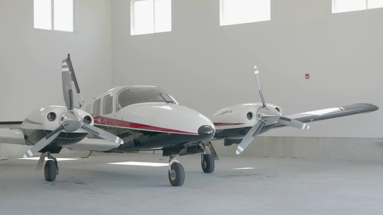 Static Shot of Twin Engine Piper Seneca in Hangar with Closing Doors