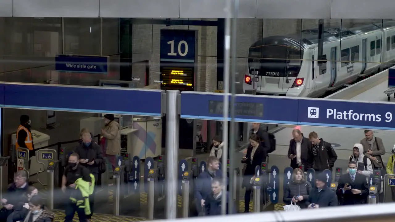 Passengers Exiting Ticket Barriers After Arriving From Train At Kings Cross Station