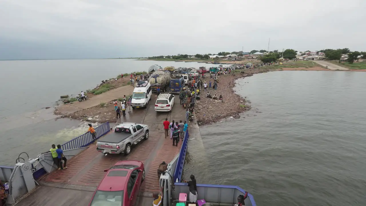 Passengers and Vehicles Disembark Cargo Barge on River Afram High Angle Shot