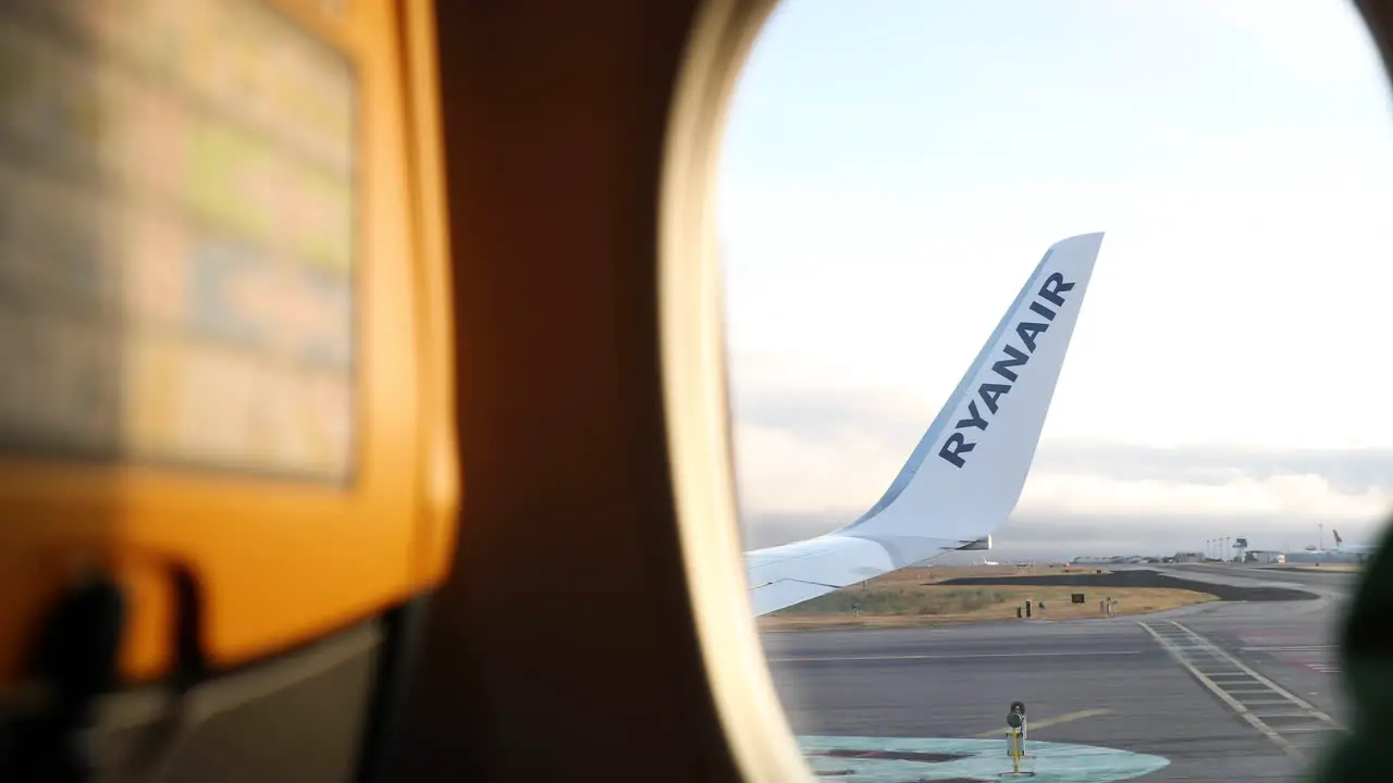 Looking Through Window Of An Airplane During Flight From Lisbon Airport In Portugal POV