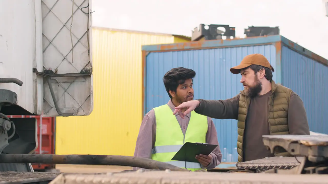 Boss And Worker Organizing A Truck Fleet In A Logistics Park While They Consulting A Document 1