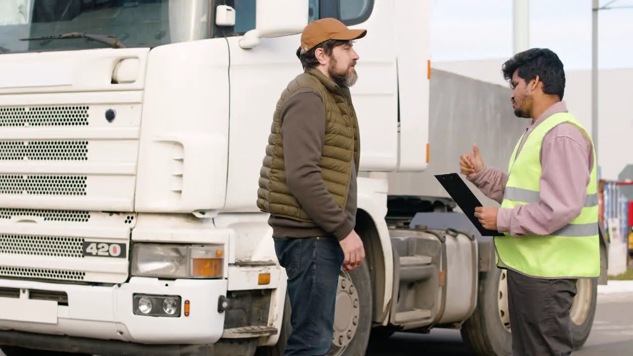 Boss And Worker Organizing A Truck Fleet In A Logistics Park