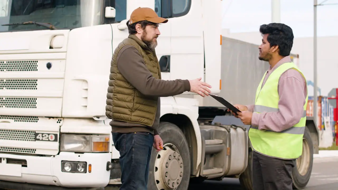 Boss And Worker Organizing A Truck Fleet In A Logistics Park 1