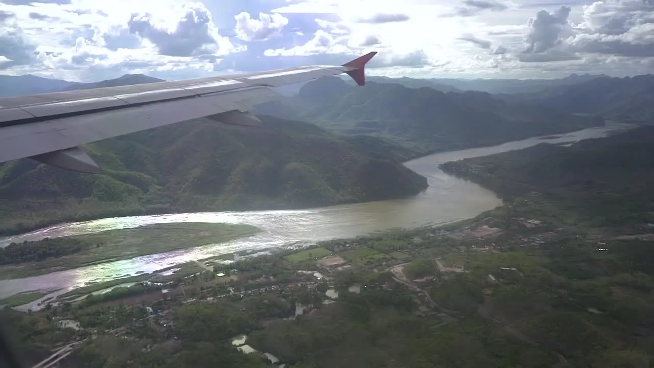 looking outside the airplane window when the plane is passing the mekong river in Laos