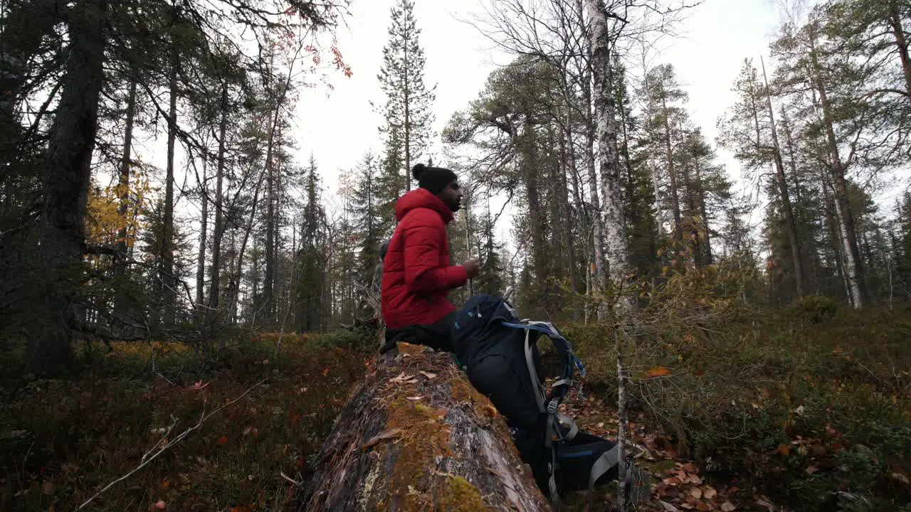 A brown guy having a snack during a hike