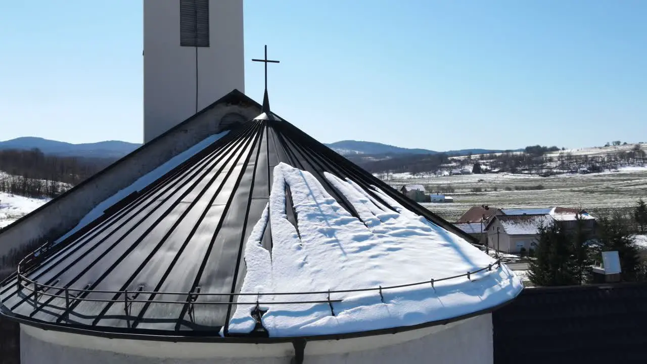 Revealing footage of Krizopolje village church tower on a sunny winter day